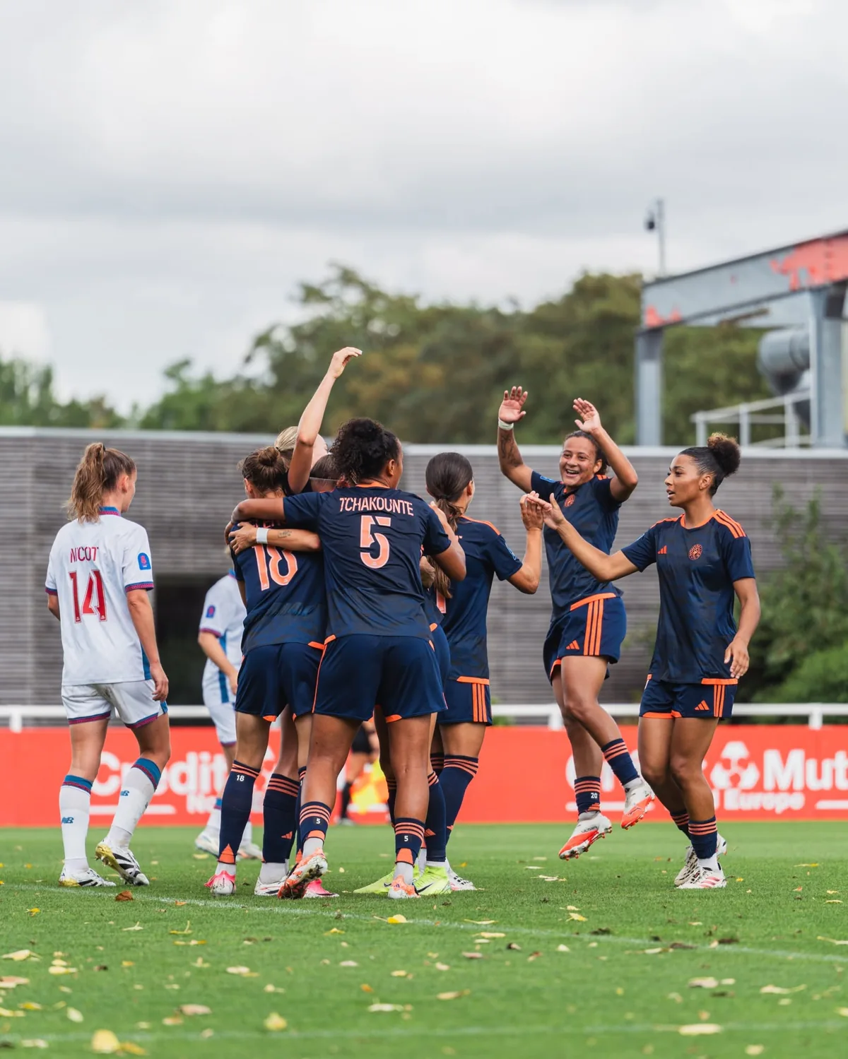 Montpellier FC women celebrating together on the pitch